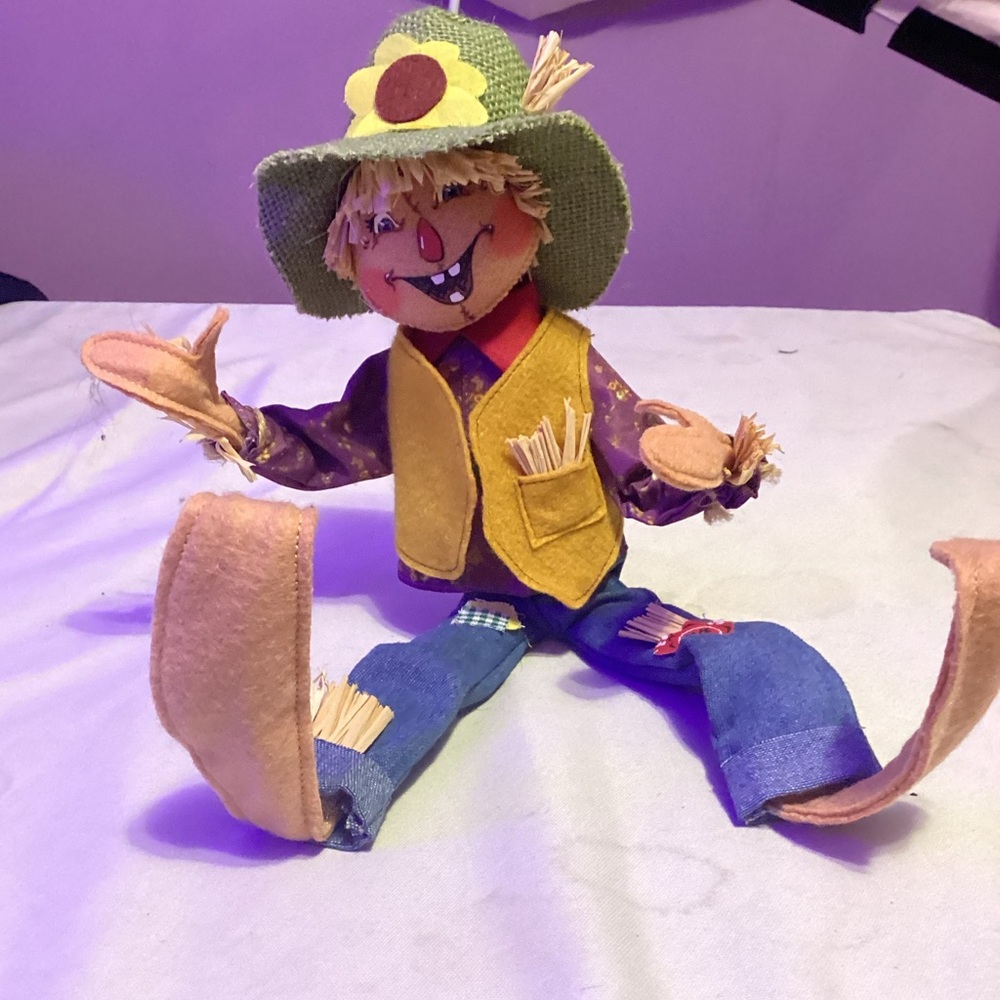 This is a scarecrow Halloween decoration with wire arms and legs.